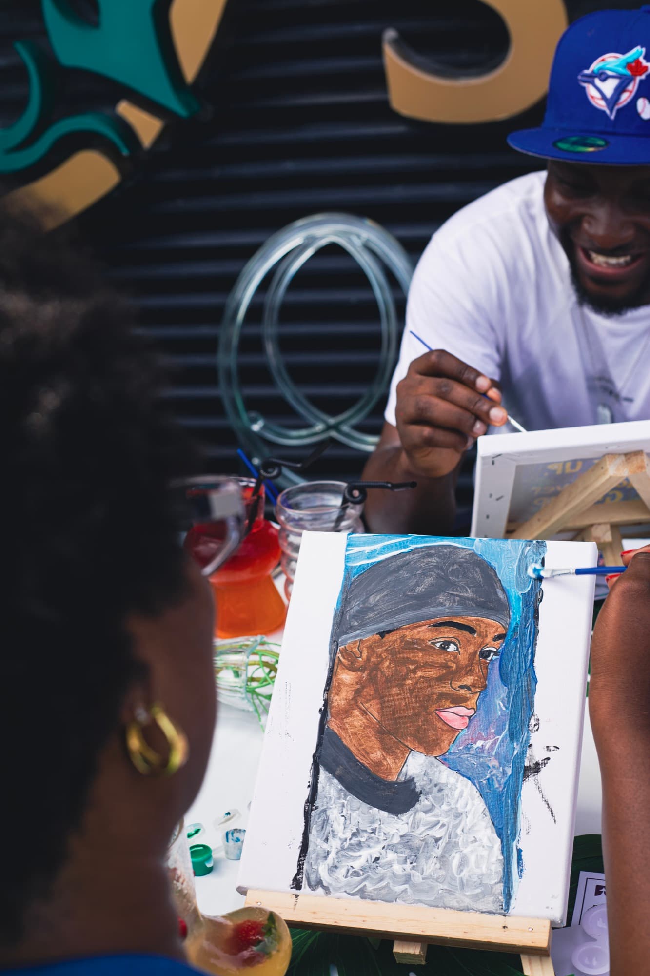 A guest painting a portrait at the Sip & Paint session.