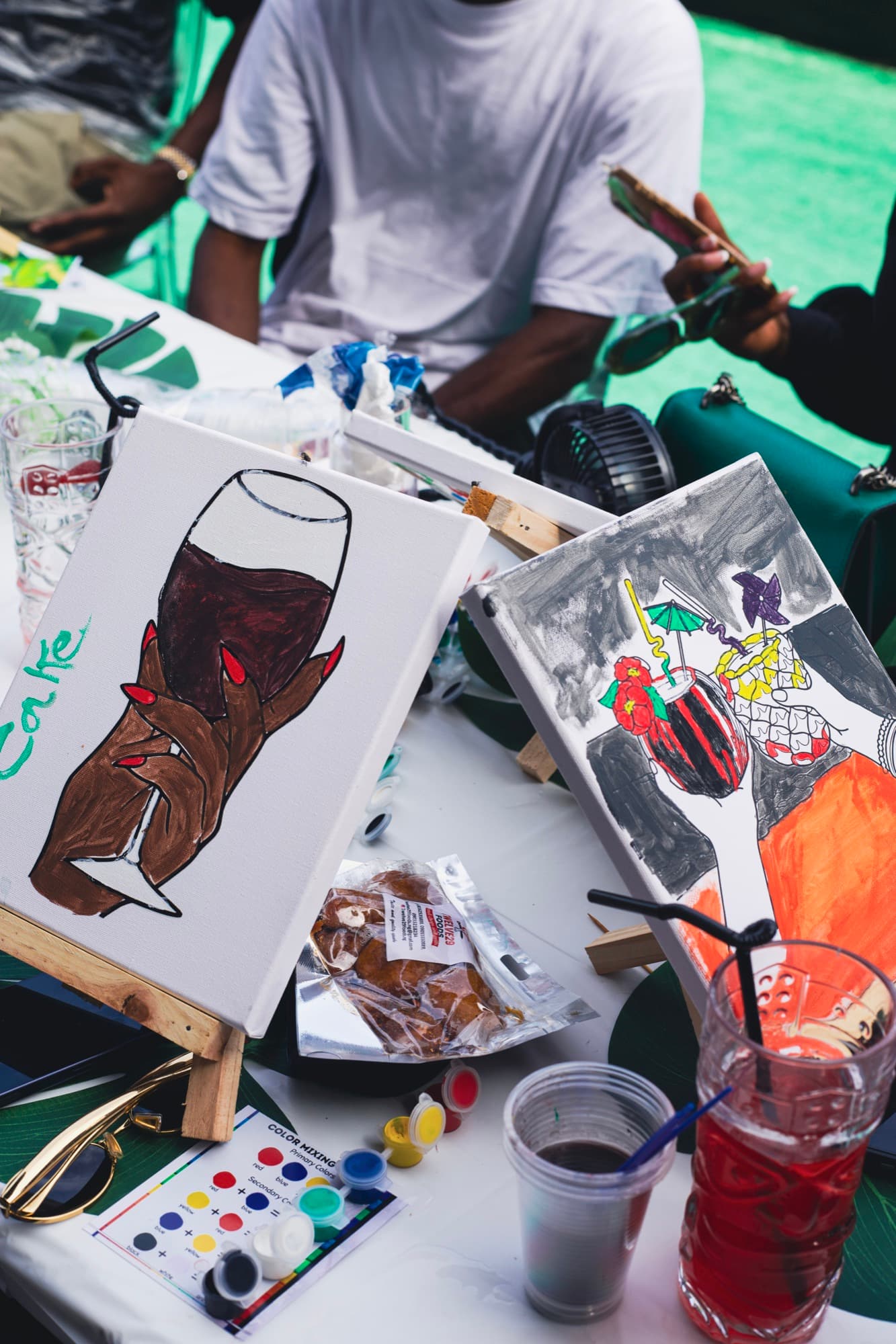 A finished painting alongside a drink at the Sip & Paint session.
